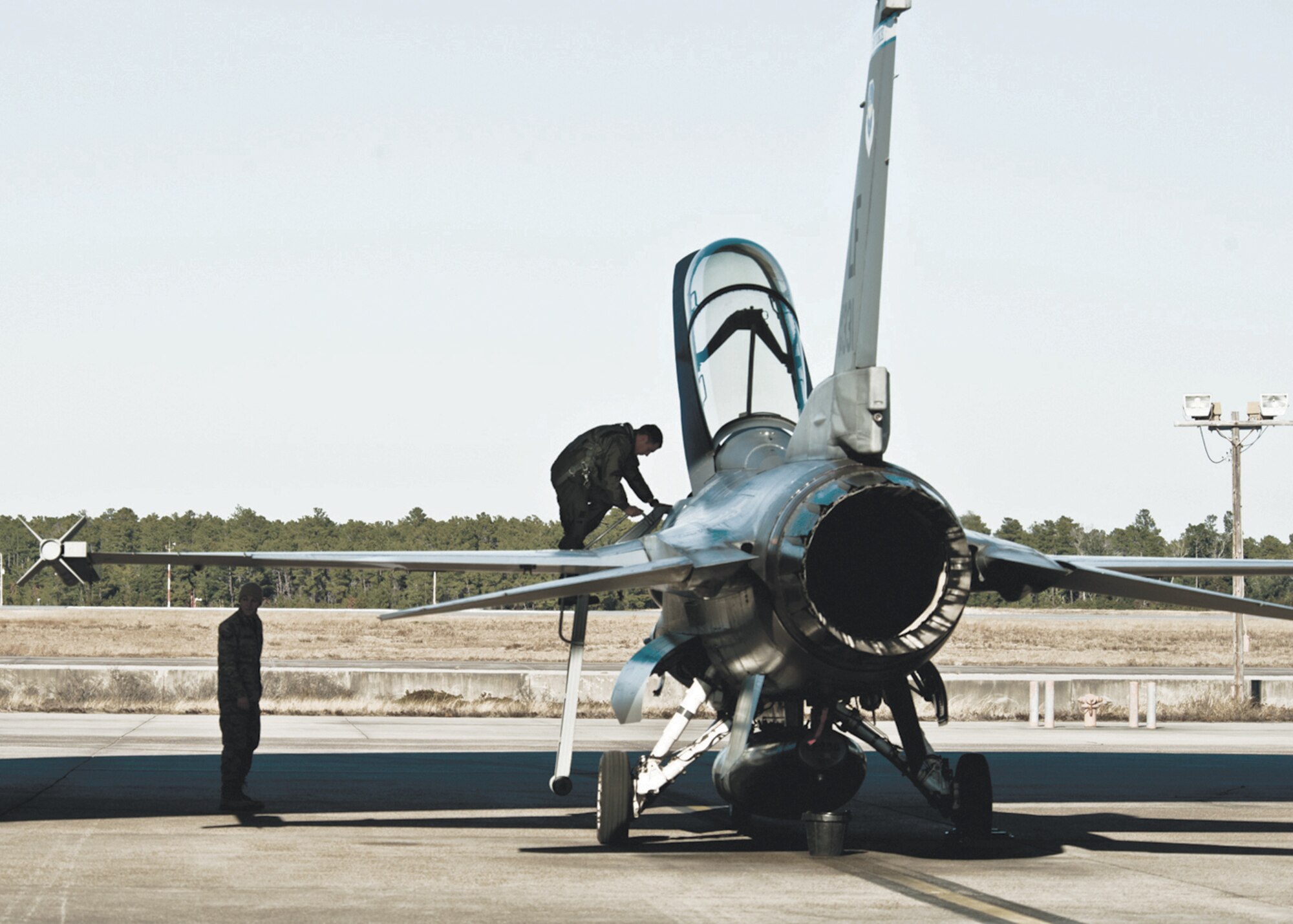 Maj. Craig Andrie, 62nd Fighter Squadron pilot, steps down from an F-16 upon arrival at Eglin Air Force Base, Fla., Jan. 13th.  Four F-16s from Luke were brought to Eglin to help prepare pilots and maintainers for the arrival of the F-35.  (U.S. Air Force photo/Samuel King Jr.)