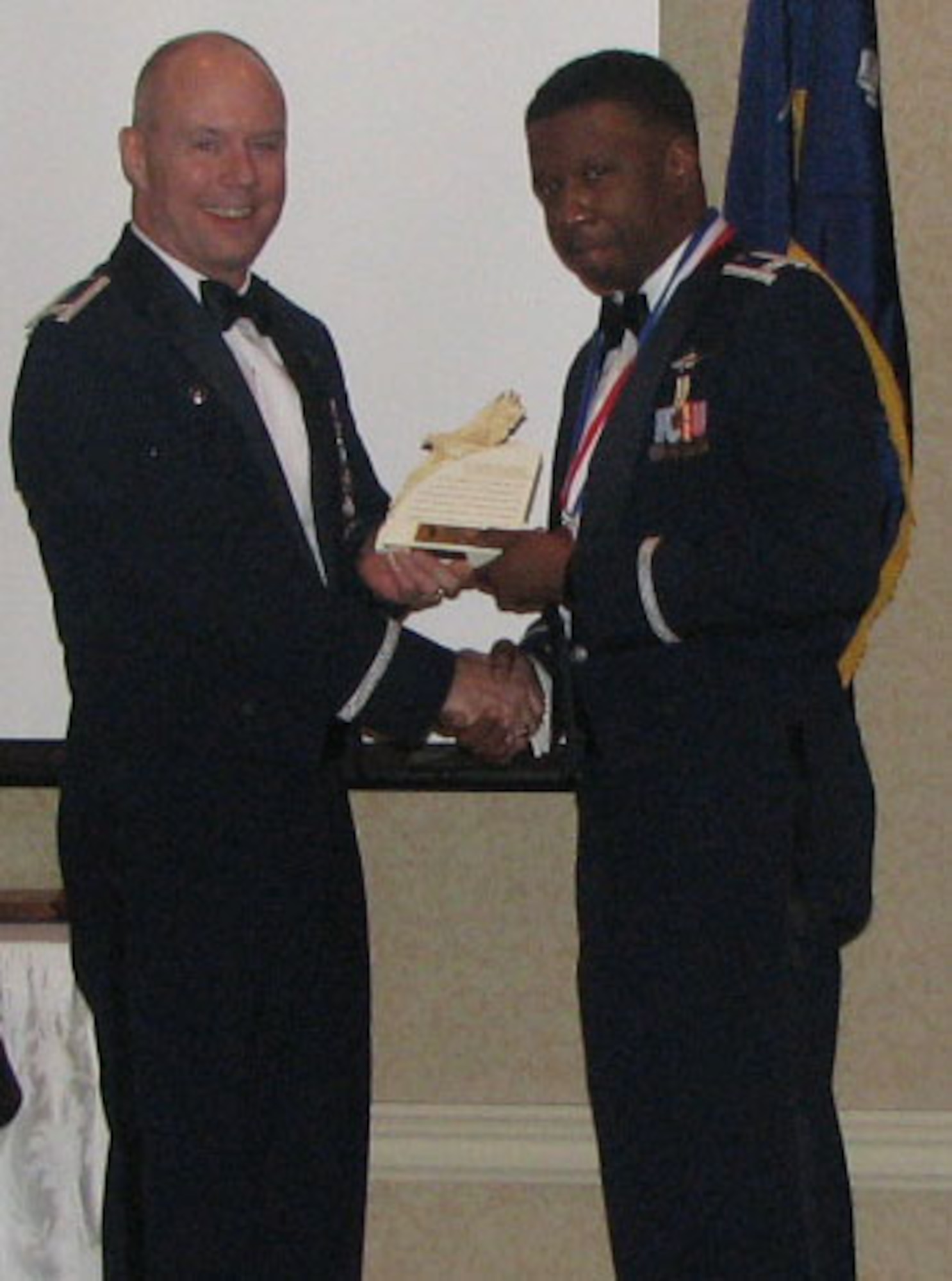EADS Commander Col. John Bartholf presents the Outstanding Company Grade Officer of the Year Award to Capt. Broderick Nettes. EADS held its annual awards banquet on Jan. 21. 