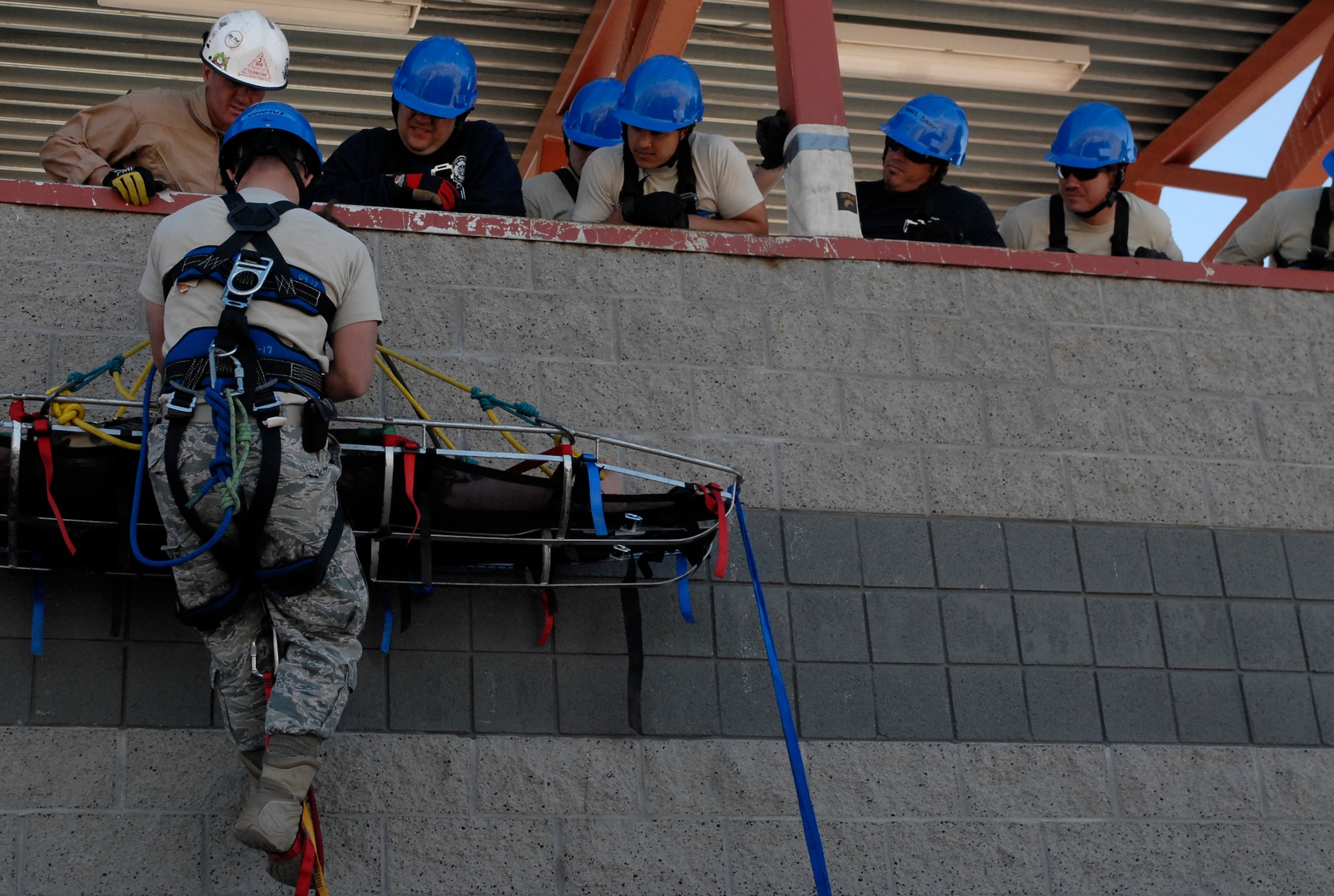 Instructor Joe Gomos, 312th Training Squadron, Goodfellow Air Force Base, Texas, instructs Senior Airman Donie Novotny, 56th Civil Engineer Squadron, on how to perform a basket operation Jan. 20th during the Rescue Technician 1 Course held at the Glendale Regional Public Safety Training Center.  (U.S. Air Force photo/Airman 1st Class Sandra Welch)