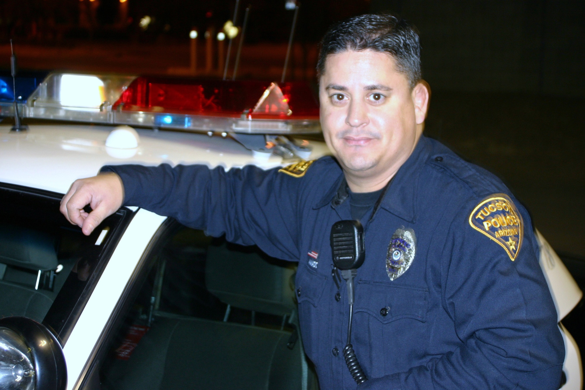 DAVIS-MONTHAN AIR FORCE BASE, Ariz. - Tucson Police Department Officer, Marcos Amado, not only serves his city, but his country as well. One weekend a month and two weeks a year he goes by Tech. Sgt. Amado and serves as a Reservist at the 943rd Rescue Group here. Both jobs, civilian and reserve, he works in the law enforcement field - as an Airmen he serves as a combat arms training and maintenance (CATM) instructor. He admits it's a balancing act at times when he has a long shift, attends a Unit Traning Assembly and then reports back for his police job at the end of a weekend. Having a positive attitude keeps him in good graces with both his military and police supervisors. (U.S. Air Force photo/Maj. Aaron Milner)