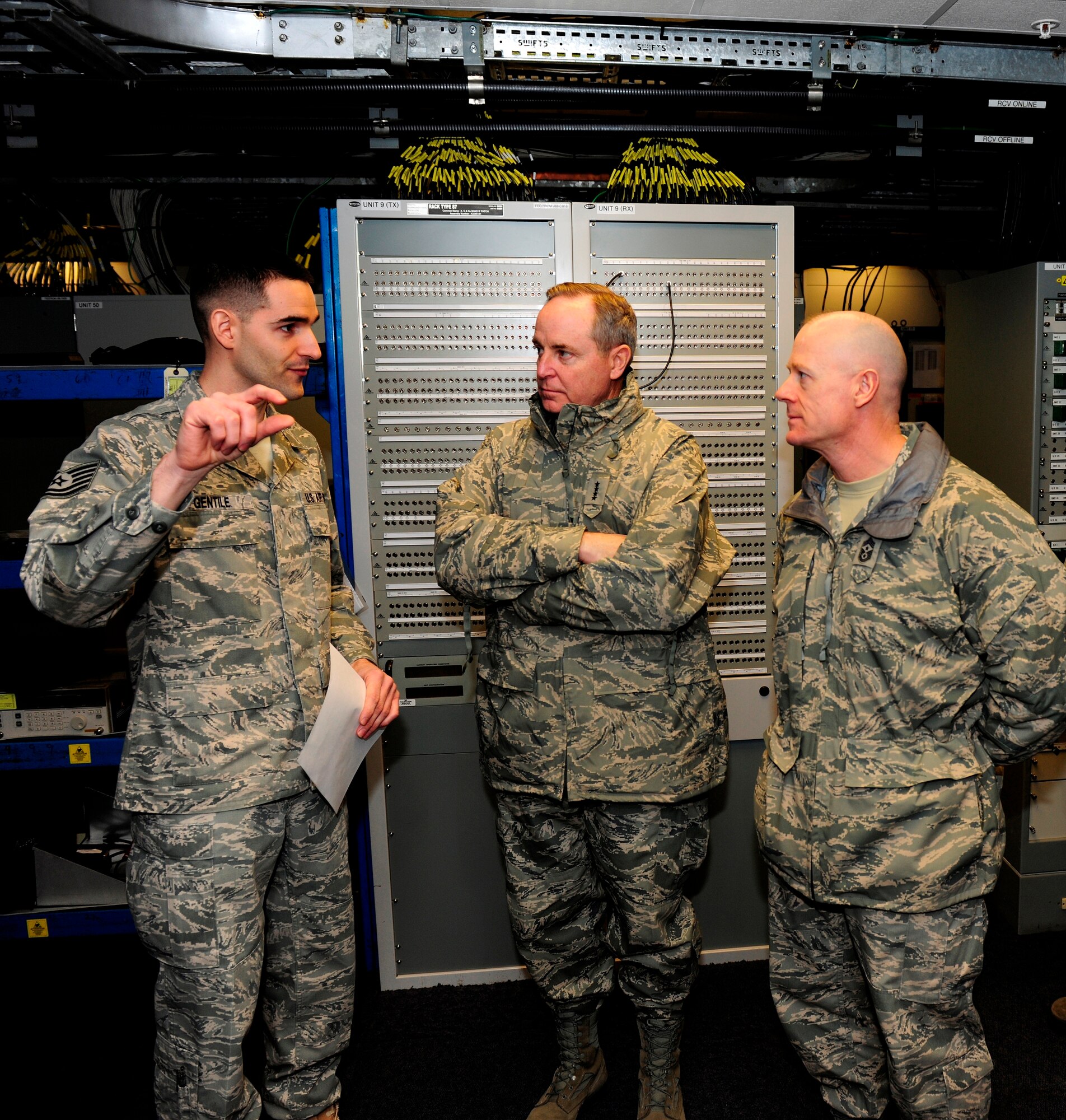 Tech. Sgt. Jesse Gentile explains the capabilities of the GSC-52(V7) Hybridized Satellite Terminal to Gen. Mark Welsh and Chief Master Sgt. David Williamson, Jan. 25, 2011. The United States Air Forces in Europe commander and command chief visited the base at part a familiarization tour of 501st Combat Support Wing bases in the United Kingdom. Behind Sergeant Gentile is a Rack Type 87 Integrated Patch Panel. (U.S. Air Force photo by Tech. Sgt. John Barton)