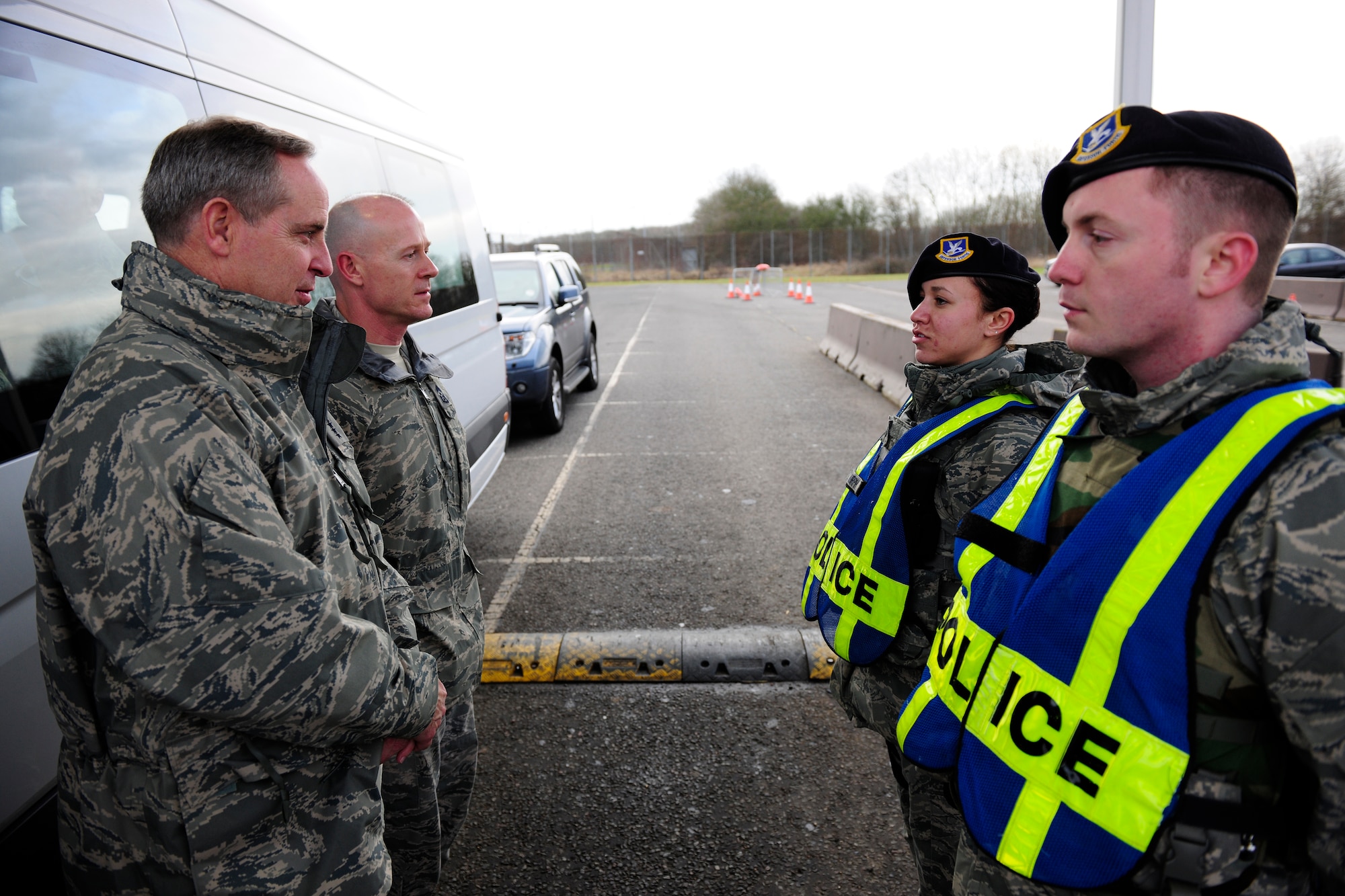 Airman 1st Class Brianna Murph and Senior Airman Seth Dorrity give a post briefing to Gen. Mark Welsh and Chief Master Sgt. David Williamson at the entry gate of RAF Molesworth, Jan. 25, 2011. The United States Air Forces in Europe commander and command chief visited the base at part a familiarization tour of 501st Combat Support Wing bases in the United Kingdom. (U.S. Air Force photo by Tech. Sgt. John Barton)