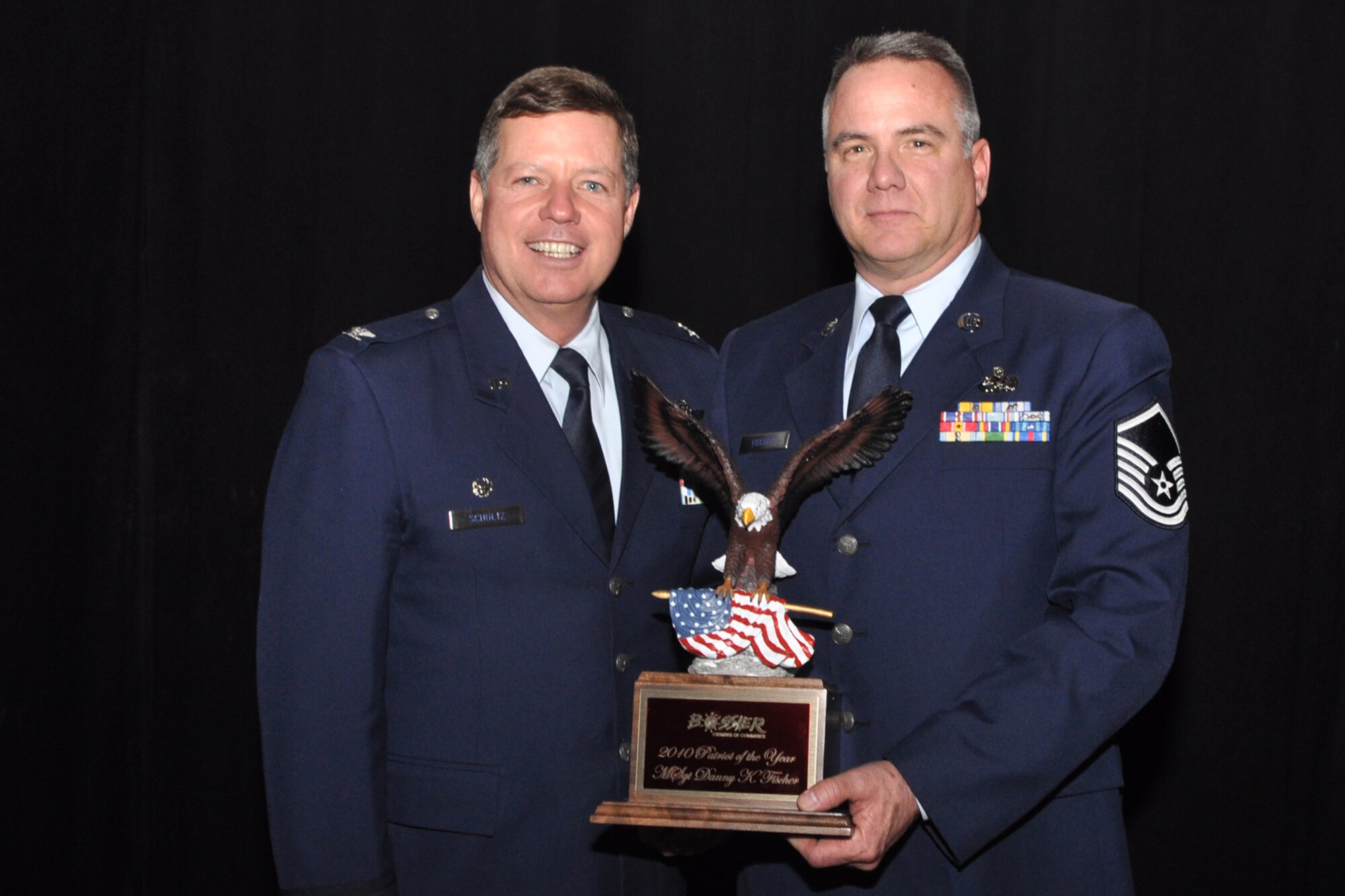 Col. Keith Schultz, commander, 307th Operations Group, poses for a photo with Master Sgt. Danny K. Fischer, B-52 armament systems supervisor, 307th Maintenance Squadron, during the Bossier Chamber of Commerce’s 63rd Annual Membership Banquet at the Horseshoe Riverdome in Bossier City, La., Jan.25, 2011. Sergeant Fischer won the award for “2010 Patriot of the Year,” Military Reserves category. In addition to his duties in Air Force, Sergeant Fischer is also a K9 Search and Rescue Bloodhound Handler. He won out over two additional nominees from Air Force Reserve units at Barksdale Air Force Base, La. The other nominees for the Reserve category were Technical Sgt. Jeffrey S. Walston, a public affairs technician with the 307th Bomb Wing and Senior Airman Kimberly Simon, a flight avionics specialist from the 917th Aircraft Maintenance Squadron. (U.S. Air Force photo/Tech. Sgt. Jeff Walston)   