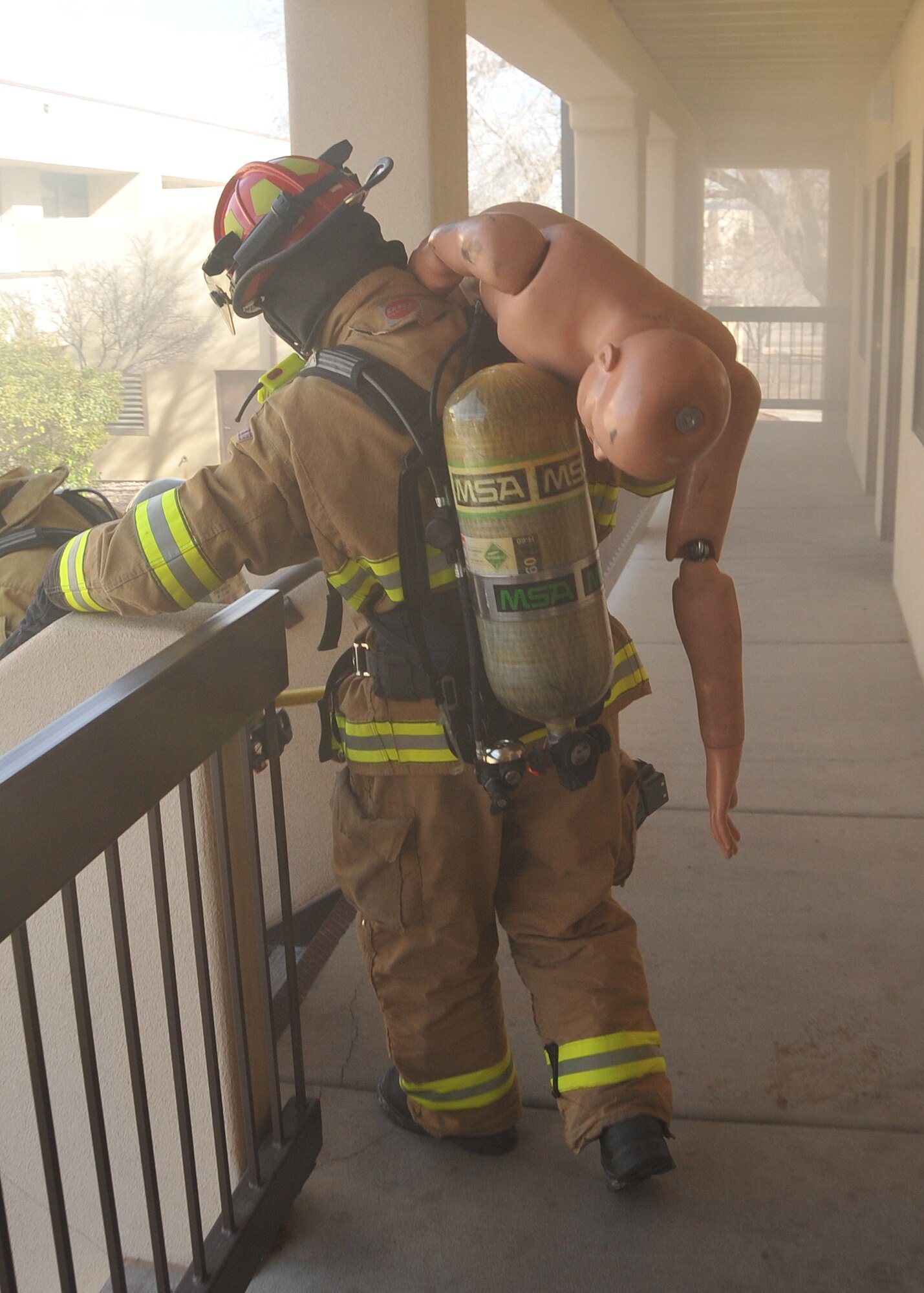 A Kirtland Air Force Base firefighter evacuates a ‘fire victim’ Jan. 25 from Building 20352 during an exercise.   
Team Kirtland participated in an exercise Jan. 24 to 28 in preparation for the Operational Readiness Inspection in March.
The exercise included various elements to prepare units for the upcoming ORI.
U.S. Air Force Photo by Todd Berenger
