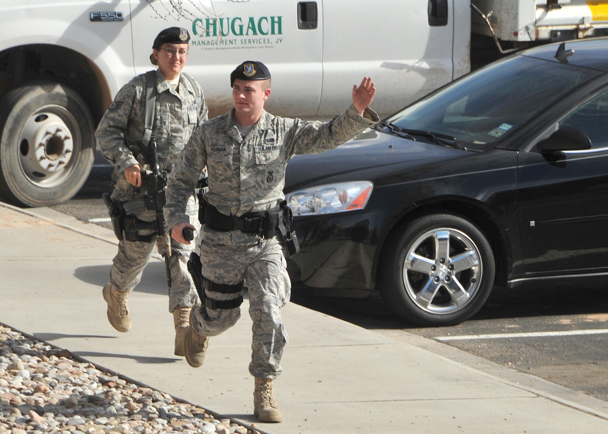 377th Security Forces Airman 1st Class Mark Fourman and Staff Sgt. Laura Kulich, first responders on the scene, motion to people outside Building 20352 to get back Jan. 24. A suspicious package was found in the Bowling Center as part of an operational readiness exercise.    
Team Kirtland participated in an exercise Jan. 24 to 28 in preparation for the Operational Readiness Inspection in March.
The exercise included various elements to prepare units for the upcoming ORI.
U.S. Air Force Photo by Todd Berenger
