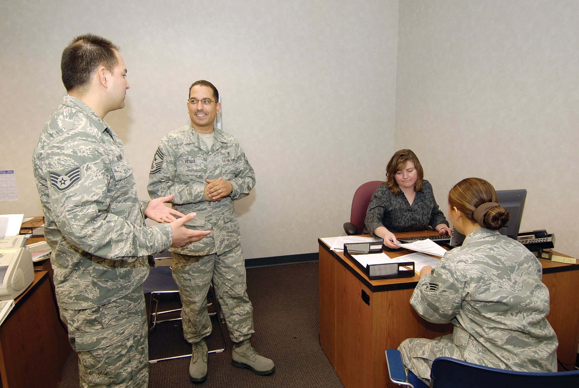 As tax season gets underway, Tinker’s Volunteer Income Tax Assistance program will again serve the military family for free.  VITA tax office non-commissioned officer in charge, Staff Sgt. Albert Ramirez, explains the features of the program to 72nd Air Base Wing Command Chief Master Sgt. Kevin Vegas.  Nearby, tax program manager Cammy Drebes answers tax questions for Senior Airman Edrianne Flores-Tullis, 72nd Security Forces Squadron.