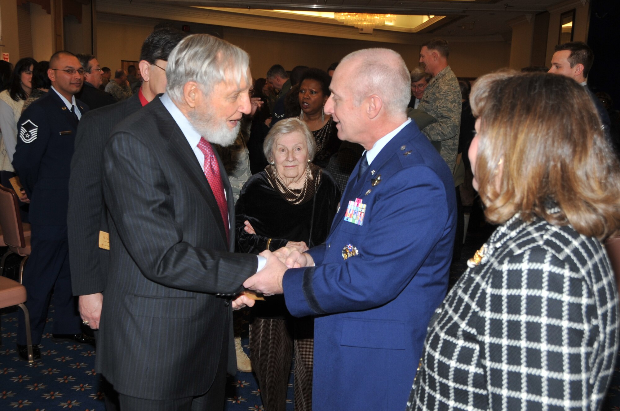 Brig. Gen. Garrett Harencak greets Leon Smith, a nuclear pioneer, at the change of command ceremony Jan. 20.  U.S. Air Force Photo by Todd Berenger