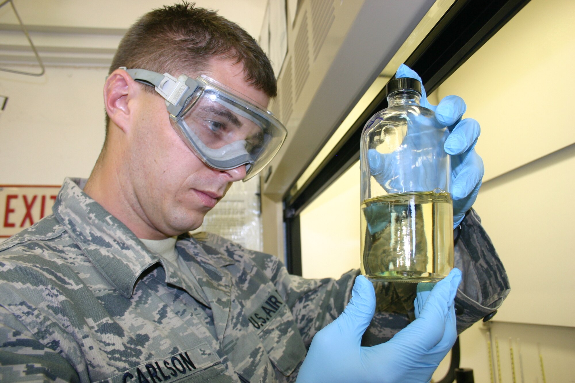 Staff Sgt. Benjamin Carlson, NCOIC of the 6th Logistics Readiness Squadron Fuels Lab, examines a sample of jet fuel. Preserving the precious liquid is what is behind constant monitoring and planning at MacDill Air Force Base, ensuring no more is used during KC-135 missions than is needed.