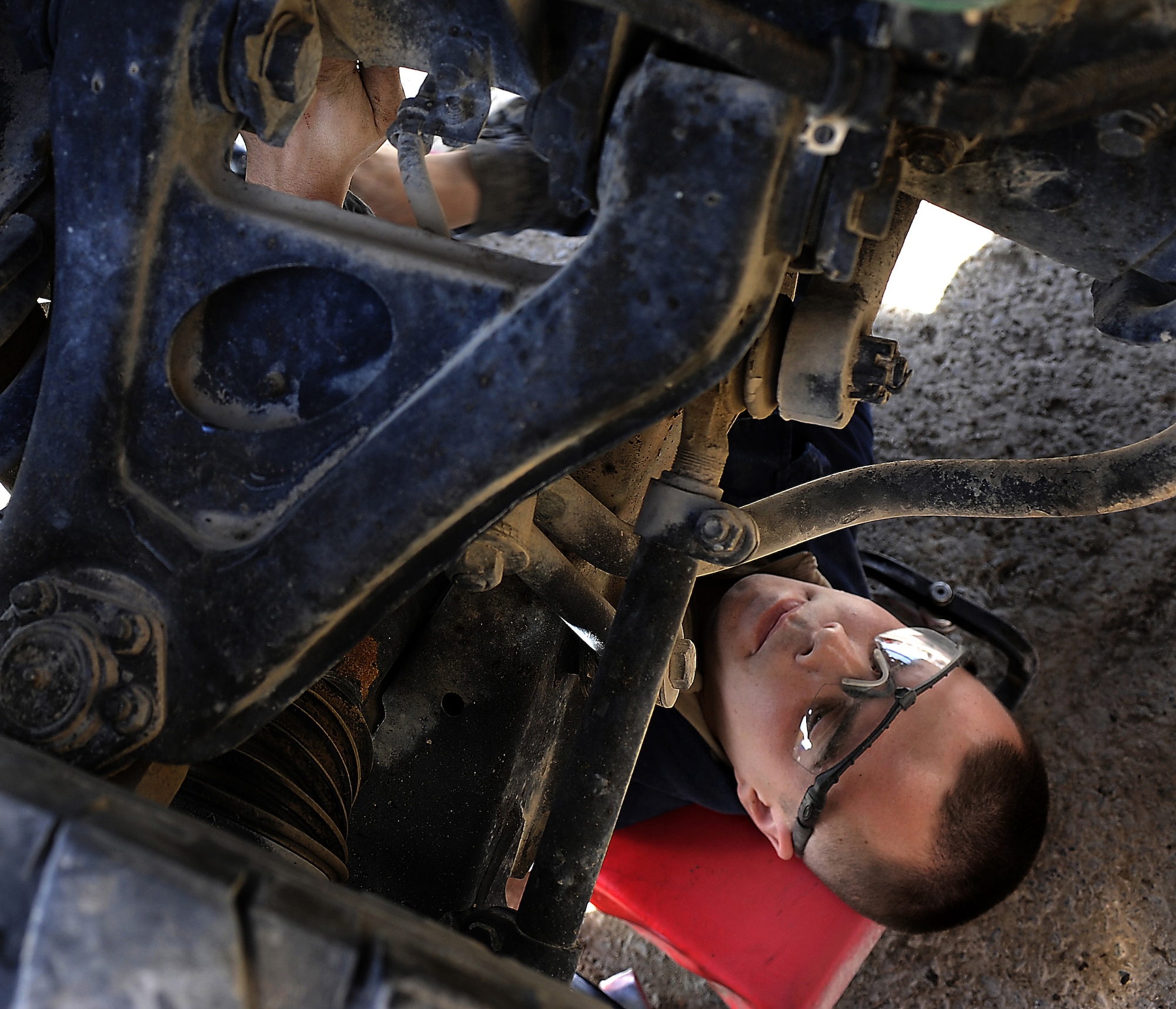 Airman 1st Class Josh Edwards removes an additional part to gain access to a HUMVEE's brake assembly Jan. 27, 2011, at Kandahar Airfield, Afghanistan. The 451st Expeditionary Logistics Readiness Squadron vehicle management team is responsible for about 1,000 vehicles in the wing's inventory. Airman Edwards, from Malmstrom Air Force Base, Mont., is a special purpose vehicle mechanic assigned to the 451st ELRS. (U.S. Air Force photo/Senior Airman Willard E. Grande II/Released)