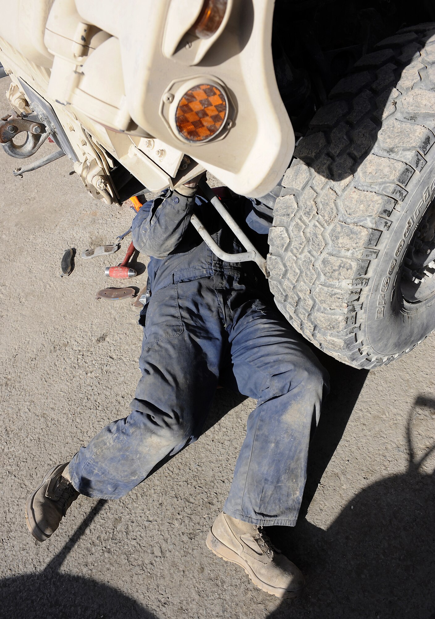Airman 1st Class Josh Edwards replaces a brake assembly on a HUMVEE Jan. 27, 2011, at Kandahar Airfield, Afghanistan. The 451st Expeditionary Logistics Readiness Squadron vehicle management team is responsible for about 1,000 vehicles in the wing's inventory. Airman Edwards, from Malmstrom Air Force Base, Mont., is a special purpose vehicle mechanic assigned to the 451st ELRS. (U.S. Air Force photo/Senior Airman Willard E. Grande II/Released)