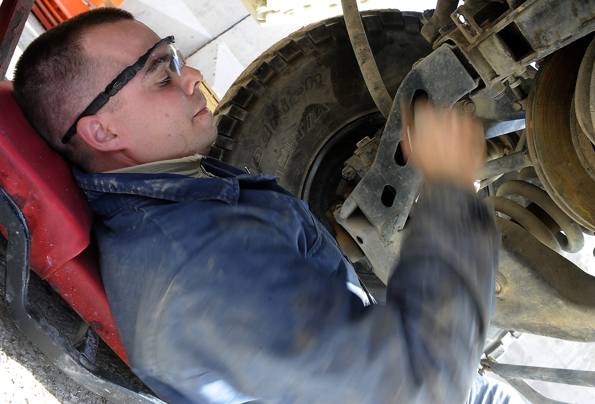 Airman 1st Class Josh Edwards loosens a bolt while replacing a brake assembly on a vehicle Jan. 27, 2011, at Kandahar Airfield, Afghanistan. The 451st Expeditionary Logistics Readiness Squadron vehicle management team is responsible for about 1,000 vehicles in the wing's inventory. Airman Edwards, from Malmstrom Air Force Base, Mont., is a special purpose vehicle mechanic assigned to the 451st ELRS.(U.S. Air Force photo/Senior Airman Willard E. Grande II/Released)