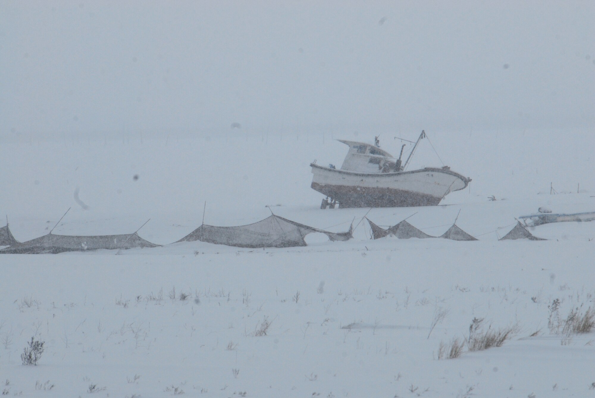 A boat sits in a tidal flat covered in snow near Byeonsan Beach. (U.S. Air Force photo/Staff Sgt. Eric Burks)