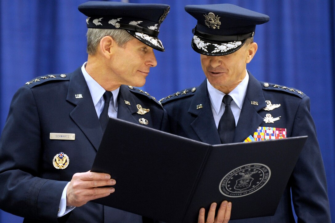 Air Force Chief of Staff Gen. Norton A. Schwartz presents the certificate of retirement to Air Force Gen. Kevin P. Chilton, outgoing commander, U.S. Strategic Command, on Offutt Air Force Base, Neb., Jan. 28, 2011.