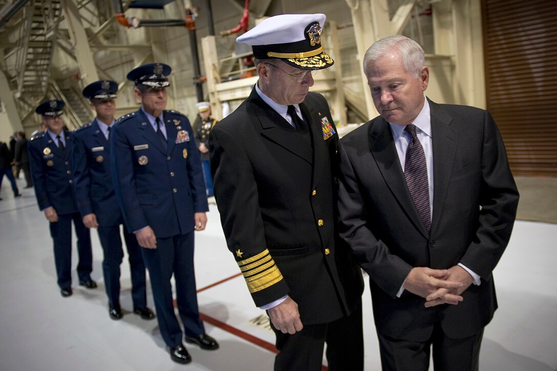 Navy Adm. Mike Mullen, chairman of the Joint Chiefs of Staff, speaks with Defense Secretary Robert M. Gates before the U.S. Strategic Command change-of-command ceremony on Offutt Air Force Base, Neb., Jan. 28, 2011. Air Force Gen. Kevin P. Chilton was relieved by Air Force Gen. C. Robert Kehler, who retired after a 34-year career in which he was the first former astronaut to achieve the four-star general officer rank.