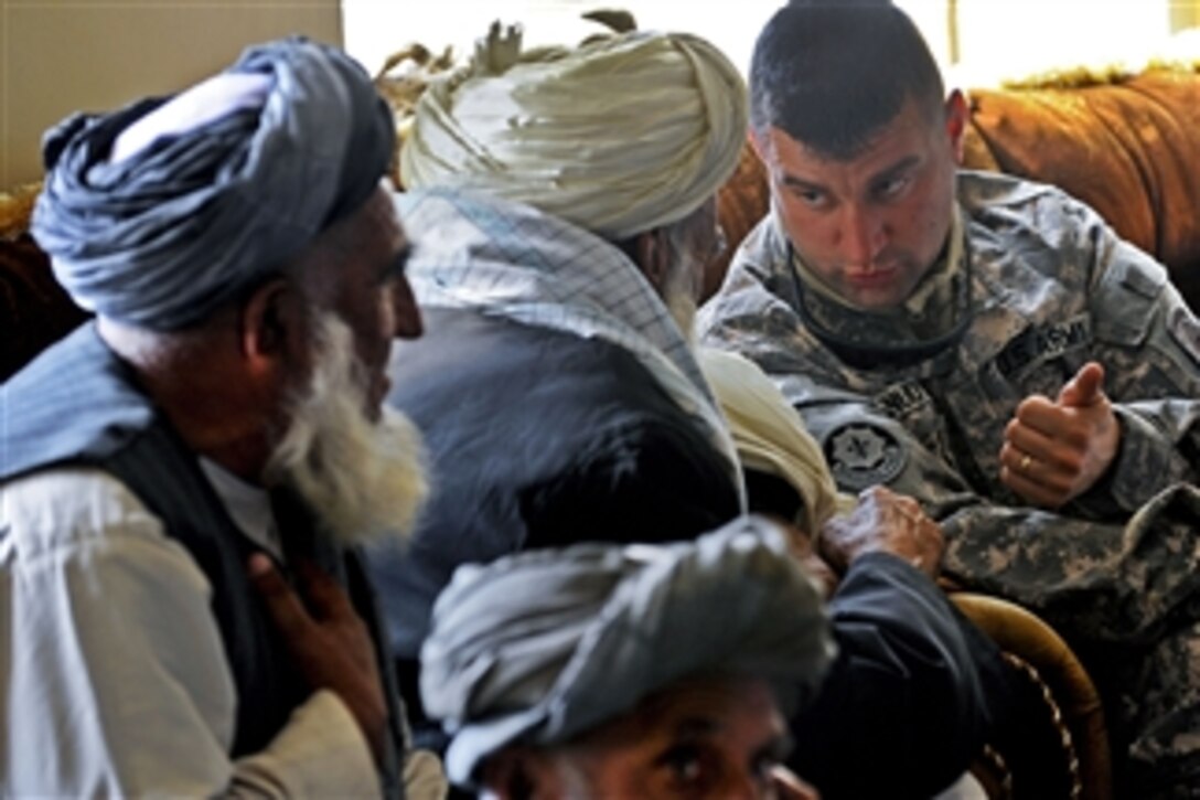 U.S. Army 2nd Lt. Paul Knudtson speaks to a Shah Joy village elder during a shura at the Shah Joy District Center in Afghanistan's Zabul province on Jan. 26, 2011.  District and provincial leaders attended the shura to discuss and request support for the new Afghan local police program.  Knudtson is assigned to Provincial Reconstruction Team Zabul.  
