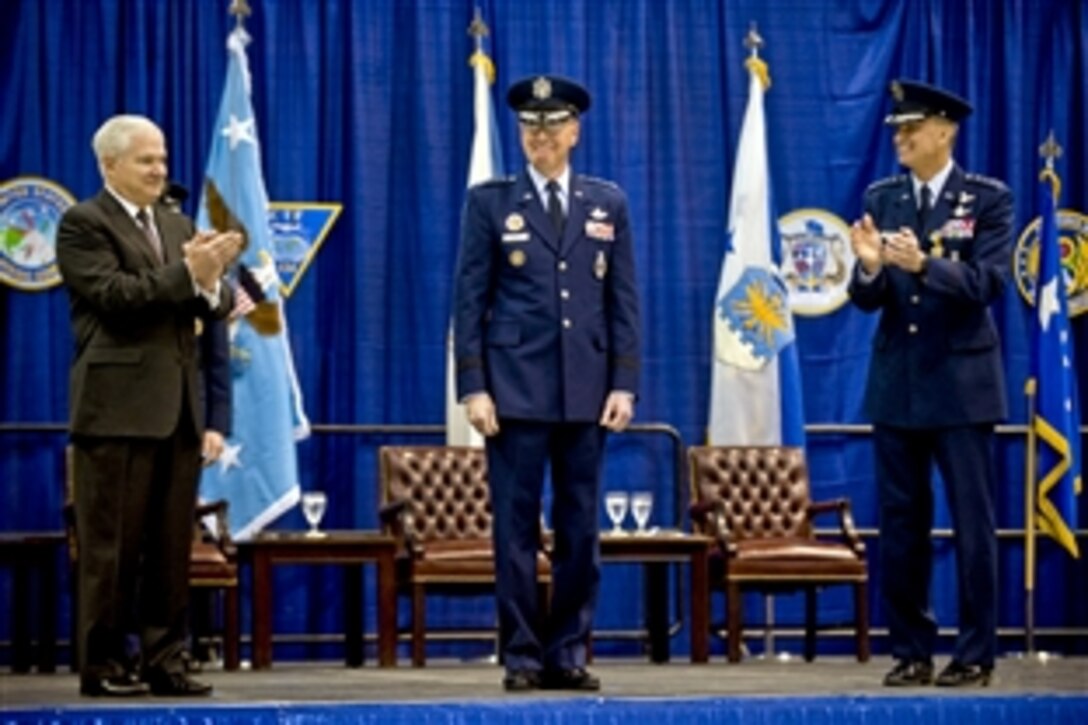 Defense Secretary Robert M. Gates and Air Force Gen. Kevin P. Chilton, outgoing commander, U.S. Strategic Command, congratulate Air Force Gen. C. Robert Kehler, incoming commander,  during the U.S. Strategic Command change-of-command ceremony on Offutt Air Force Base, Neb., Jan. 28, 2011.