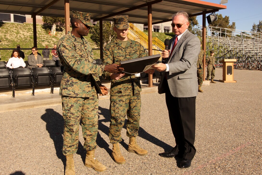Staff Sgt. Marc-Antonie Harris (left) and Staff Sgt. Benni Bennett (center) both platoon commanders, separations platoon, School of Infantry West, Camp Pendleton, accept a Continuous Process Improvement award, Jan. 28, from Harry Jackson (right), Headquarters Marine Corps, CPI awards program, in honor of their Student Administrative Separation project. Previously, the average time to administratively separate a Marine from SOI-W was 36 days. The annual cost to hold the students at SOI reached a cost of $831,000. The SOI Student Administrative Separation project was able to cut this time in half and reduce the annual cost by $616,000 in 2010.