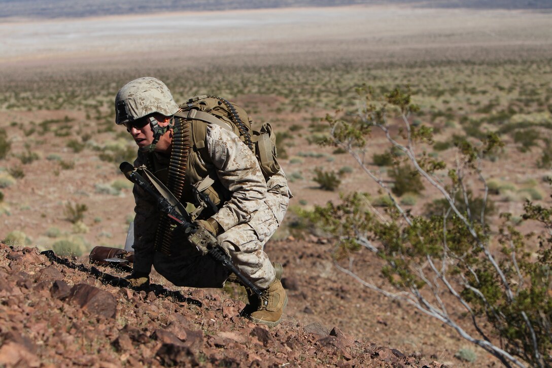 A Marine with 2nd platoon, Company G, 2nd Battalion, 7th Marine Regiment, scouts the entrenched enemy position before calling up the main force during an entrenched-enemy assault exercise at the Lead Mountain training area Jan. 29, 2011.