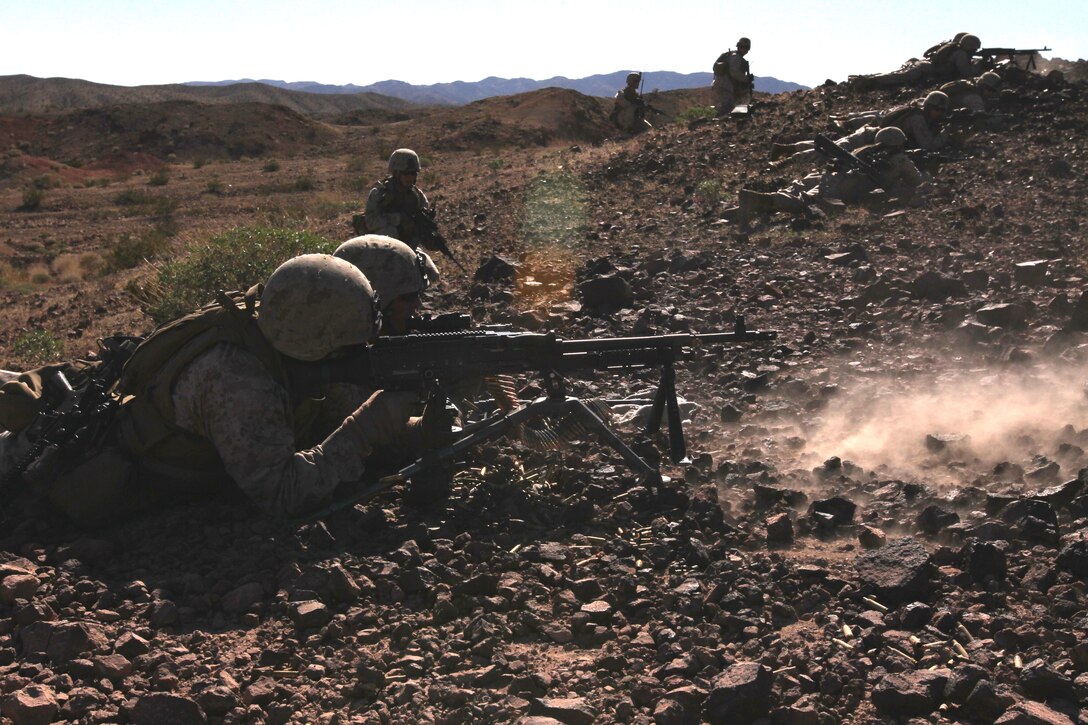 Marines with 2nd platoon, Company G, 2nd Battalion, 7th Marine Regiment, lay covering fire for their assault squad on an entrenched enemy position at Lead Mountain Jan. 29, 2011.