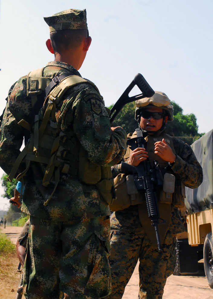 Marine LCpl. Ruben D. Gomez, from Security Cooperation Task Force (SCTF) converses with Colombian Marines from 4th Infantry Battalion and 2nd Infantry Battalion as Marines and Sailors come ashore in Covenas, Sucre, Jan. 29. SCTF is embarked aboard Gunston Hall on a scheduled deployment to the U.S. Southern Command (USSOUTHCOM) area of responsibility supporting Amphibious Southern Partnership Station 2011 (A-SPS 11). A-SPS 11 will provide the opportunity for joint operations between partner nations while exercising vital lines of communication between regional security services. (U.S. Navy photo by Mass Communication Specialist 3rd Class Lauren G. Randall)