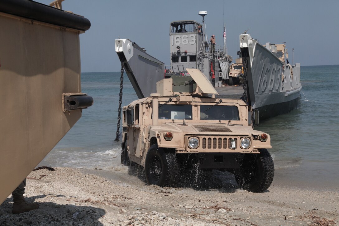 COVENAS SUCRE, Colombia (January 29, 2011) A Humvee  attached to Security Cooperation Task Force (SCTF) offloads from a landing craft unit (LCU) that disembarked from amphibious dock-landing ship USS Gunston Hall (LSD 44), Jan. 29. Gunston Hall is deployed to the U.S. Southern Command area of responsibility in support of Amphibious Southern Partnership Station 2011 (A-SPS 11). A-SPS 11 will facilitate close coordination and communication between regional partners’ civil and maritime services, resulting in strengthened cooperative partnerships.  (U.S. Army photo by Sergeant Kevin L. Pruitt)