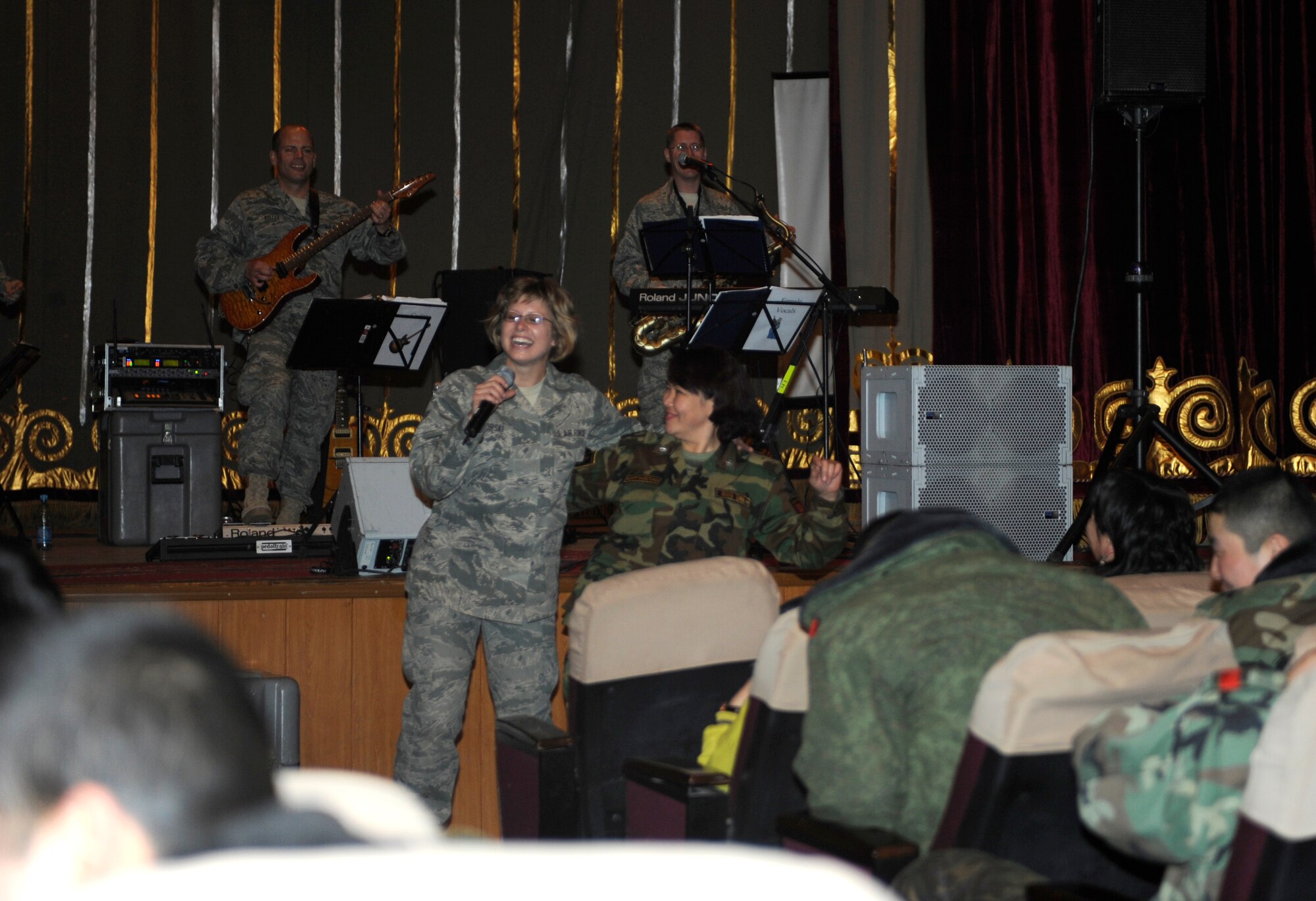 BISHKEK, Kyrgyzstan --  Airman 1st Class Carmen Emborski, U.S. Air Forces Central "Starlifter" band vocalist, shares a dance with a Kyrgyz military member at a performance in Frunze--a  Kyrgyz military academy--in Biskek, Thursday.  The Starlifter band performed a wide variety of music for the Kyrgyz military community to enjoy. (U.S. Air Force photo/ Tech. Sgt. Jerome C. Baysmore) 
