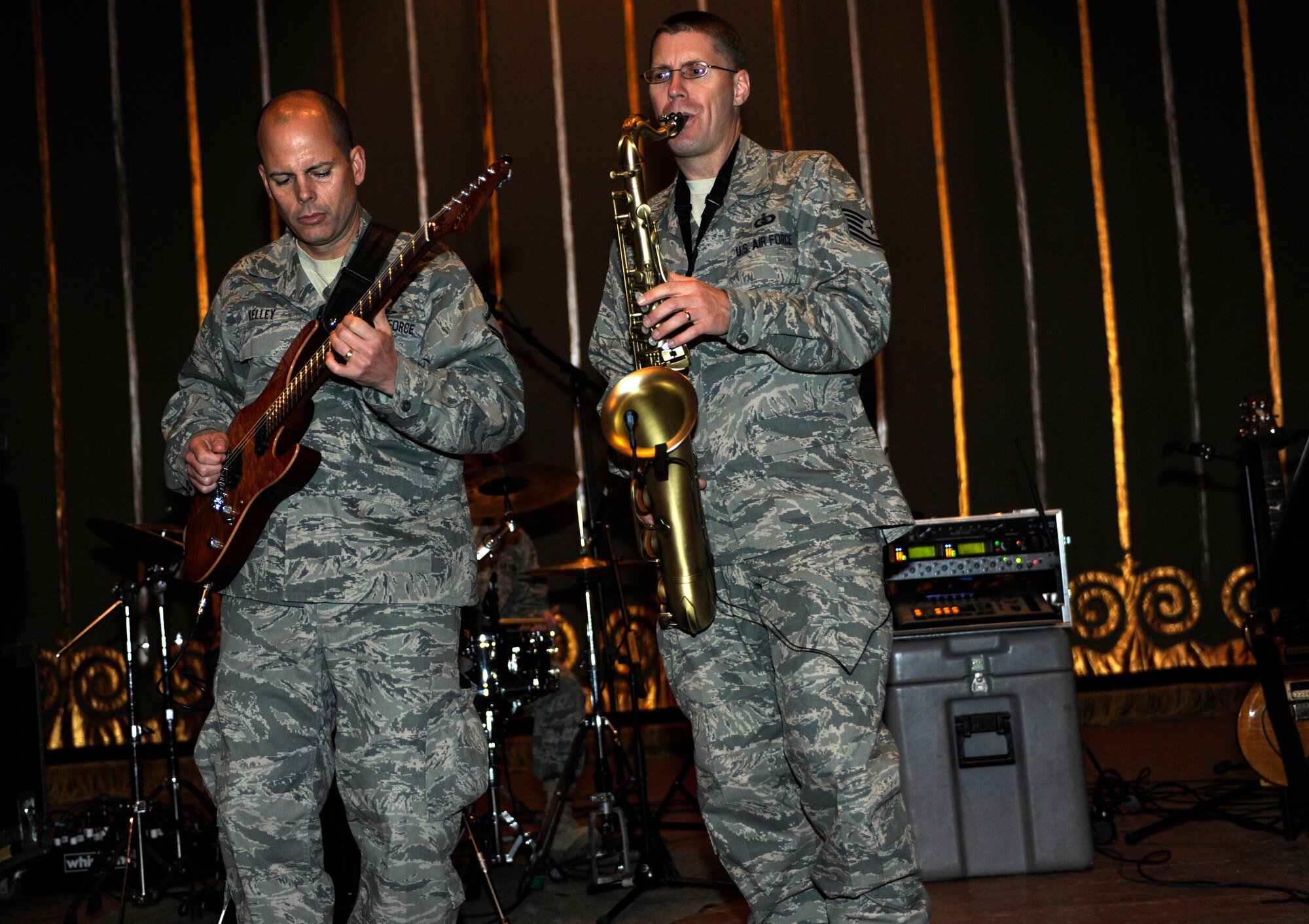 BISHKEK, Kyrgyzstan -- Master Sgt. Jerry Kelley, U.S. Air Forces Central "Starlifter" band guitarist and Tech. Sgt. Dwight Wiest, saxophonist, show their skills during a performance in Frunze--a  Kyrgyz military academy--in Biskek, Thursday.  The Starlifter band performed a wide variety of music for the Kyrgyz military community to enjoy. (U.S. Air Force photo/ Tech. Sgt. Jerome C. Baysmore) 

