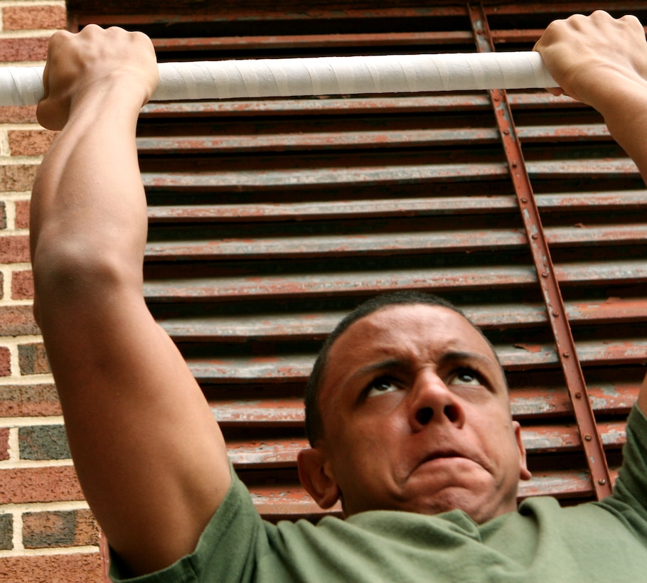 A Junior ROTC cadet from Willowridge High School in Houston, forces out one last pull-up during a physical fitness competition at Jesuit High School here Jan. 29.  Eighteen high schools from Louisiana, Texas and Mississippi competed in the 23rd Annual Jesuit High School Marine Corps JROTC Drill and Physical Fitness competition.