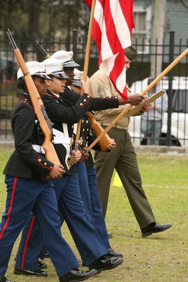 A Marine judge evaluates as cadets from Gulfport High School in Gulfport, Miss., march as a color guardduring a drill competition at Jesuit High School here Jan. 29.