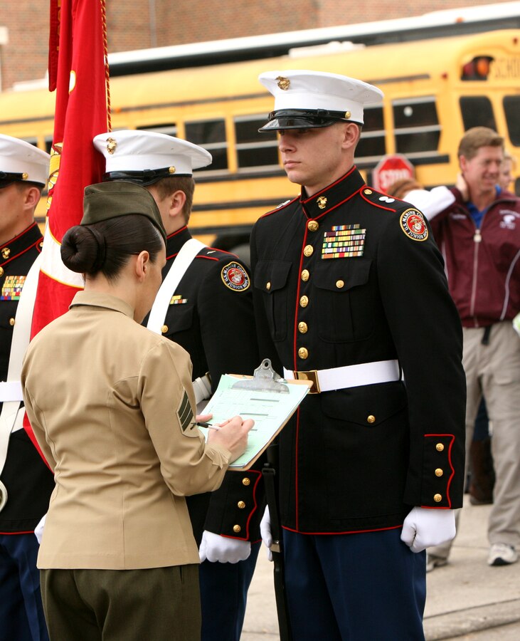 Sgt. Jeanette Ponce Benjamin, an administrative clerk at Marine Forces Reserve, inspects a color guard detail during a drill competition at Jesuit High School here Jan. 29.