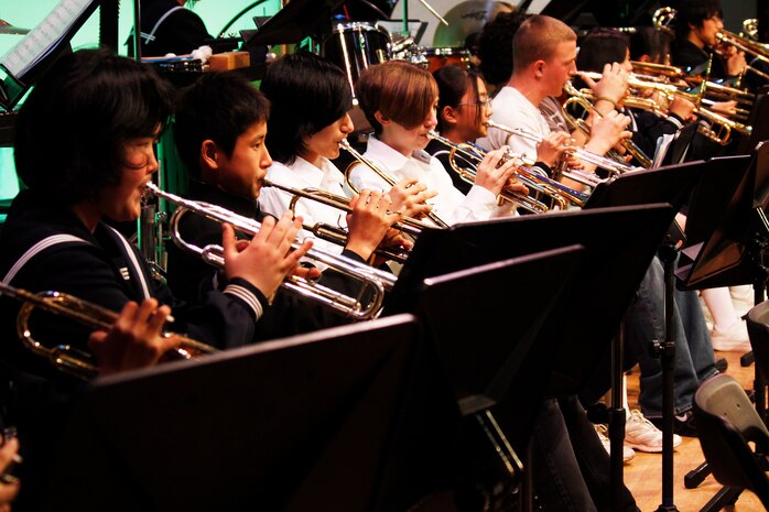 American students from Matthew C. Perry High School and Japanese students from Iwakuni Municipal Higashi Junior High School play their musical instruments together during the inaugural U.S.-Japan Friendship Concert Sunday at Iwakuni Sinfonia Concert Hall. The Chugoku-Shikoku Defense Bureau hosted the event to foster and strengthen the relationship between the station and the surrounding community.