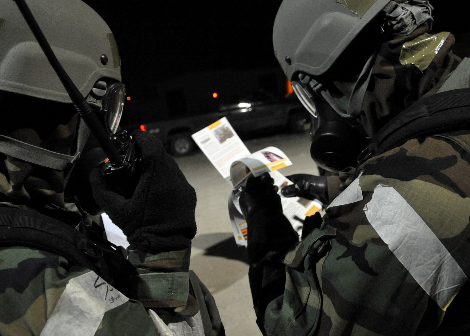 Airmen look through their Airman's Manual while conducting a Post Attack Reconnaissance sweep during Operational Readiness Exercise Beverly Bulldog 11-01 at Osan Air Base, Republic of Korea, Jan. 28. PAR Sweeps are conducted after an attack to survey the area for contamination, unidentified explosive ordnance, casualties or suspicious activity. (U.S. Air Force photo/Senior Airman Evelyn Chavez)