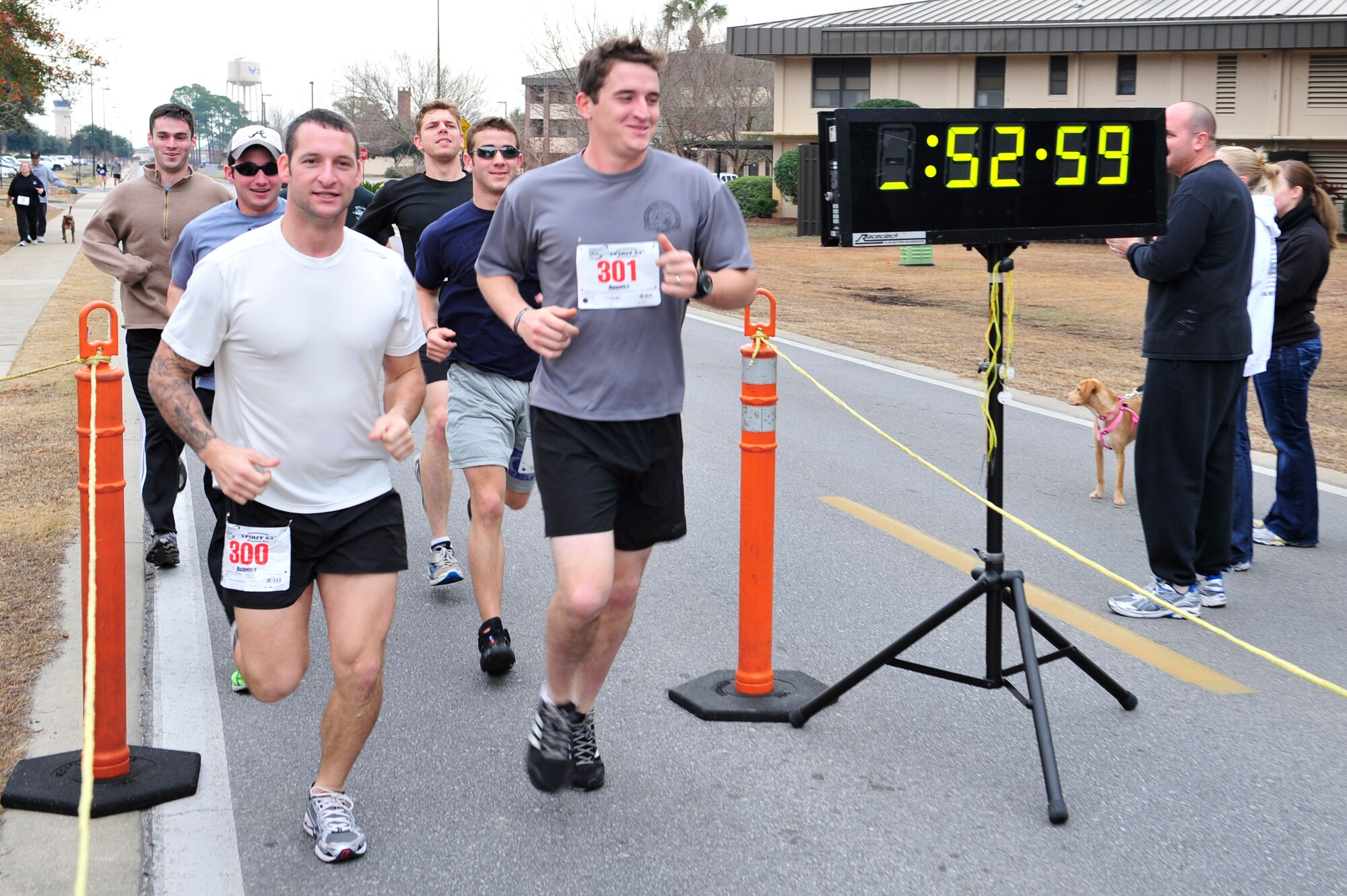 U.S. Air Force Airmen from the Special Tactics Training Squadron cross the finish line after completing the Spirit 03 14K,  Hurlburt Field, Fla., Jan. 30, 2011. The run was the first of a series of events scheduled to pay tribute to the fallen crew of Spirit 03, an AC-130H Spectre Gunship lost during Desert Storm. (U.S. Air Force photo by Staff Sgt. Stephanie Jacobs/RELEASED)