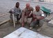 KABUL, Afghanistan - Col. Creig A. Rice (C), the former Vice Commander of the 438th Air Expeditionary Wing poses with Tech. Sgt. Darryl Guppy (L) and Tech. Sgt. Arthur Barad (R) after laying down the final tile of the Oqab morale area at the Afghan Air Force base in Kabul, Afghanistan Dec. 5. (U.S. Navy photo by Mass Communications Specialist 3rd Class Jared E. Walker/ RELEASED).