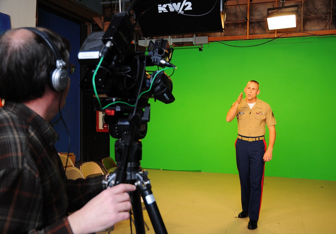KFOR STUDIOS, OKLAHOMA CITY - (right) Sgt. Daniel Jacobson a recruiter with Recruiting Station, Oklahoma City barks orders into a camera for a News Channel  4 promo spot. While at the station to produce a poolee promo, "Promo Joe" Kozlowski, creative service director, here, asked if Jacobson would like to be in another of their news content promo spots. Working relationships and regular contact with media outlets like KFOR open up publicity opportunities for recruiters.