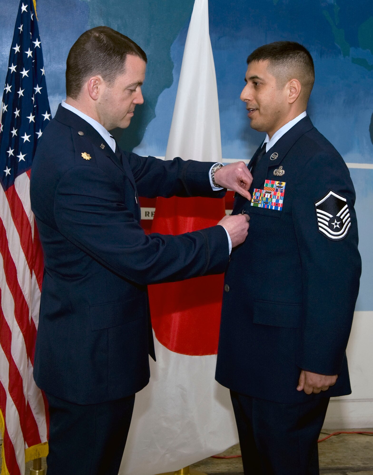 U.S Air Force Master Sgt. Alexander Arias, 35th Logistics Squadron, Section Chief, Maintenance Support Liaison, is awarded a bronze star and purple heart Jan. 28, 2011, Misawa Air Base, Japan. Sergeant Arias demonstrated the highest degree of "courage under fire" while engaging with enemy forces as a scout gunner in a coalition vehicle convoy during his deployment to Afghanistan. Despite being wounded and under direct fire, Sergeant Arias continued suppressive fire while the main body of the convoy arrived to secure the perimeter, ensuring the safety of his team. (U.S. Air Force photo by Tech. Sgt. Russell McBride/Released)