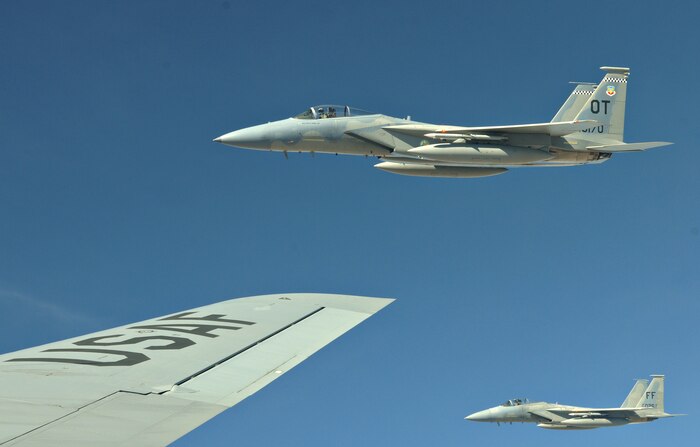 NELLIS AIR FORCE BASE, Nev. -- Two F-15 Strike Eagles begin a formation off the wingtip of a KC-135 Stratotanker after refueling during Red Flag 11-2 Jan. 27. Red Flag is a combined exercise that provides a realistic combat training environment to the U.S. and its allies. (U.S. Air Force photo/Staff Sgt. Benjamin Wilson)