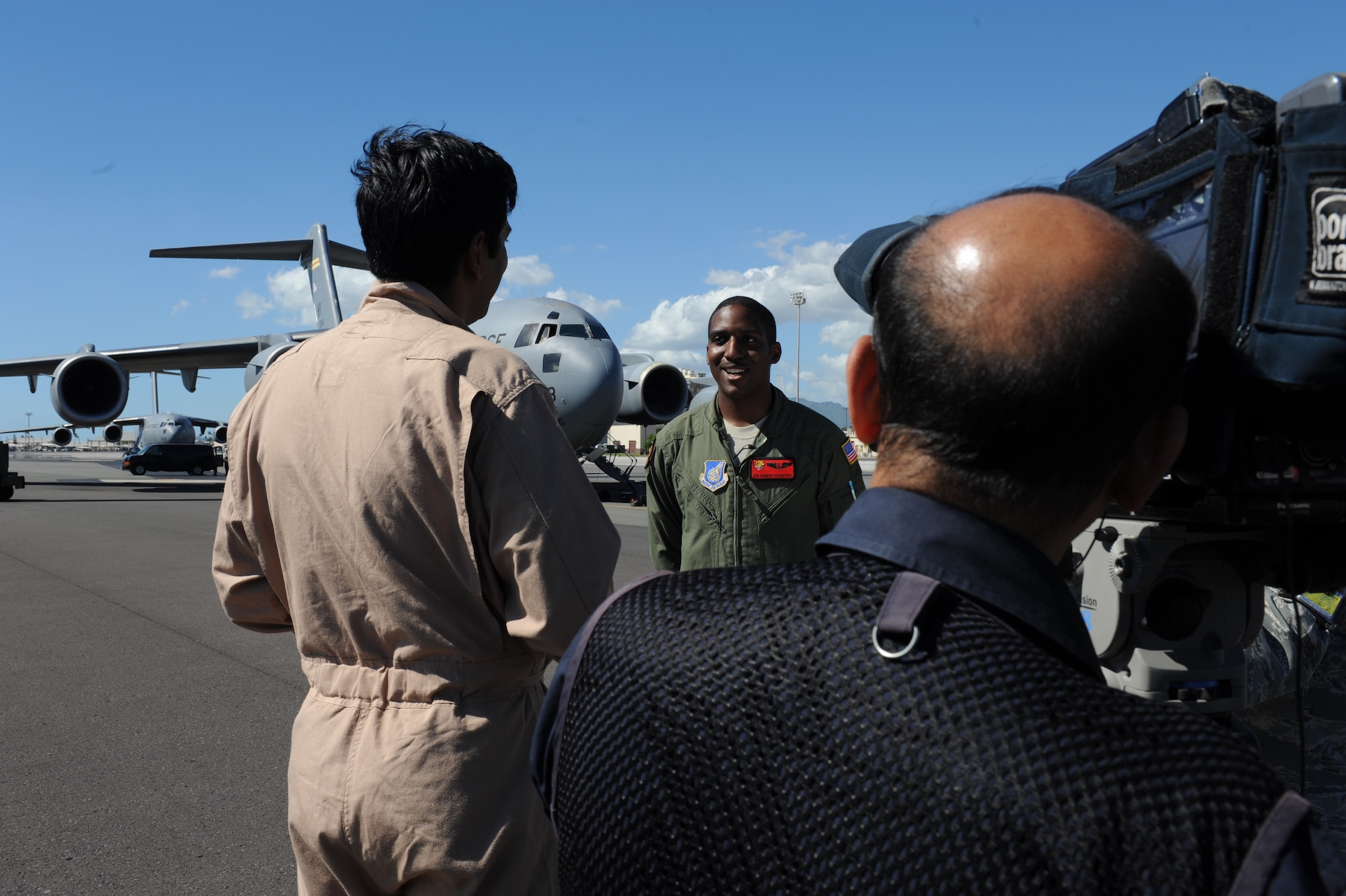 Vishnu Som, New Delhi Television station senior news anchor, interviews Airman 1st Class Robert Streeter, 535th Airlift Squadron loadmaster, following a flight aboard a C-17 on a routine training mission to Kona, Hawaii Jan. 25. The NDTV crew flew aboard the C-17 to document the capabilities of the aircraft. (U.S. Air Force photo/Airman 1st Class Lauren Main)