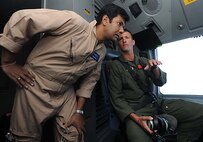 1st Lt. Matt Davis, a 535th Airlift Squadron C-17 pilot, speaks to Vishnu Som, New Delhi Tevlevision station Senior News Anchor, about the capabilities of the C-17 during a training mission to Kona, Hawaii Jan. 25. (U.S. Air Force photo/Airman 1st Class Lauren Main)