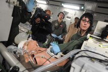 Ajmal Jami, a cameraman from the New Delhi Television station, documents the 18th Aeromedical Evacuation Squadron as they simulate a casualty exercise aboard a C-17 Jan. 25. The NDTV crew flew aboard the C-17 and documented the capabilities of the aircraft on a routine training mission to Kona, Hawaii. (U.S. Air Force photo/Airman 1st Class Lauren Main)