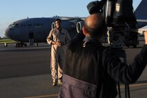 Ajmal Jami, a cameraman with New Delhi Television station, records Vishnu Som, senior news anchor with NDTV, as he speaks about the C-17s on the 15th Wing flightline Jan. 25. The NDTV crew flew aboard a C-17 and documented the capabilities of the aircraft on a routine training mission to Kona, Hawaii. (U.S. Air Force photo/Airman 1st Class Lauren Main)