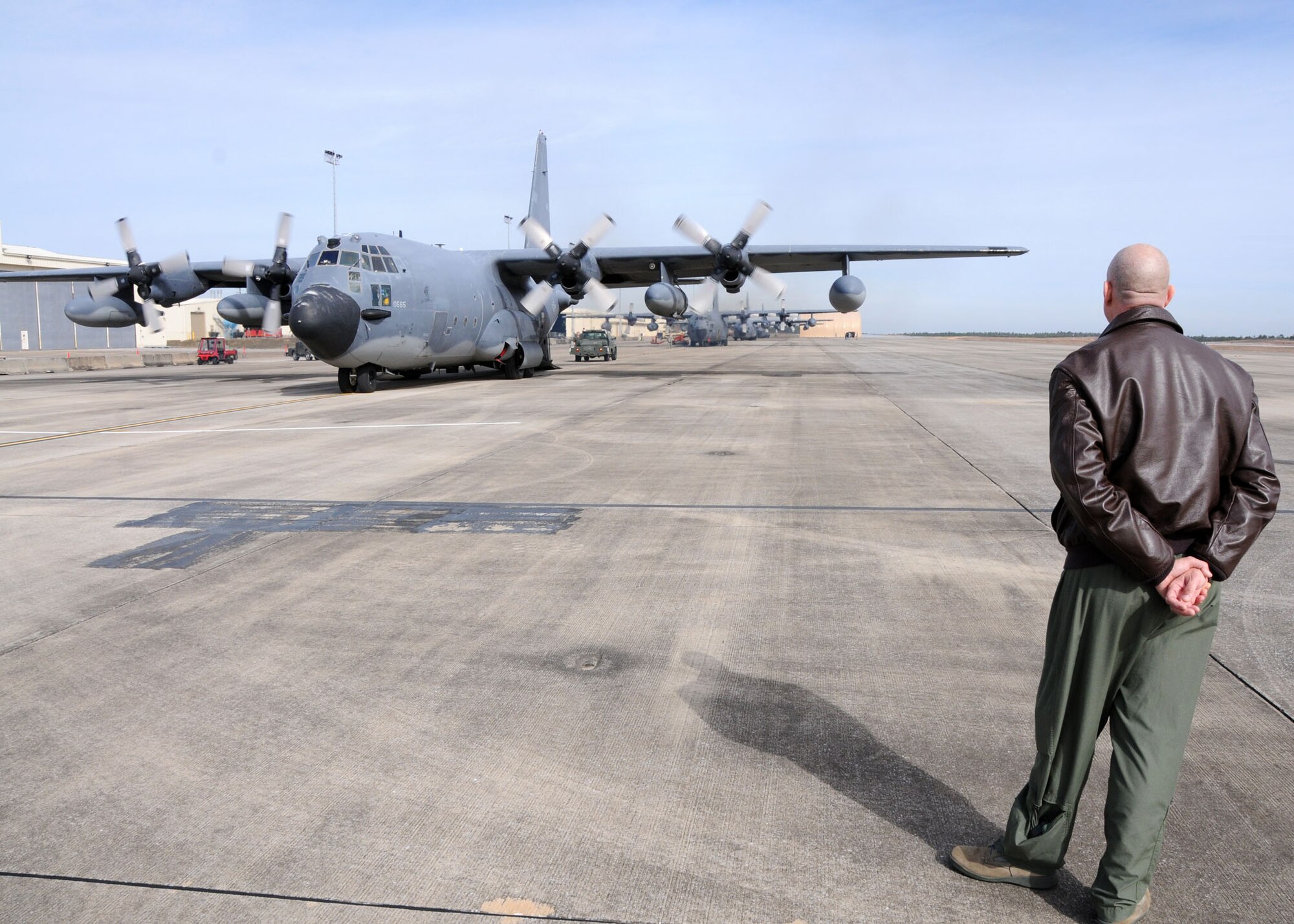 Colonel Andy Comtois, 919th Special Operations Wing commander, observes one of his MC-130E aircraft taxiing toward a parking spot on the Duke Field flightline Jan. 28.  The wing’s aircraft returned home after being temporarily stationed at nearby Eglin Air Force Base, Fla., during an eight-month airfield construction project.  (U.S. Air Force photo/Staff Sgt. Jonathan McCallum)
