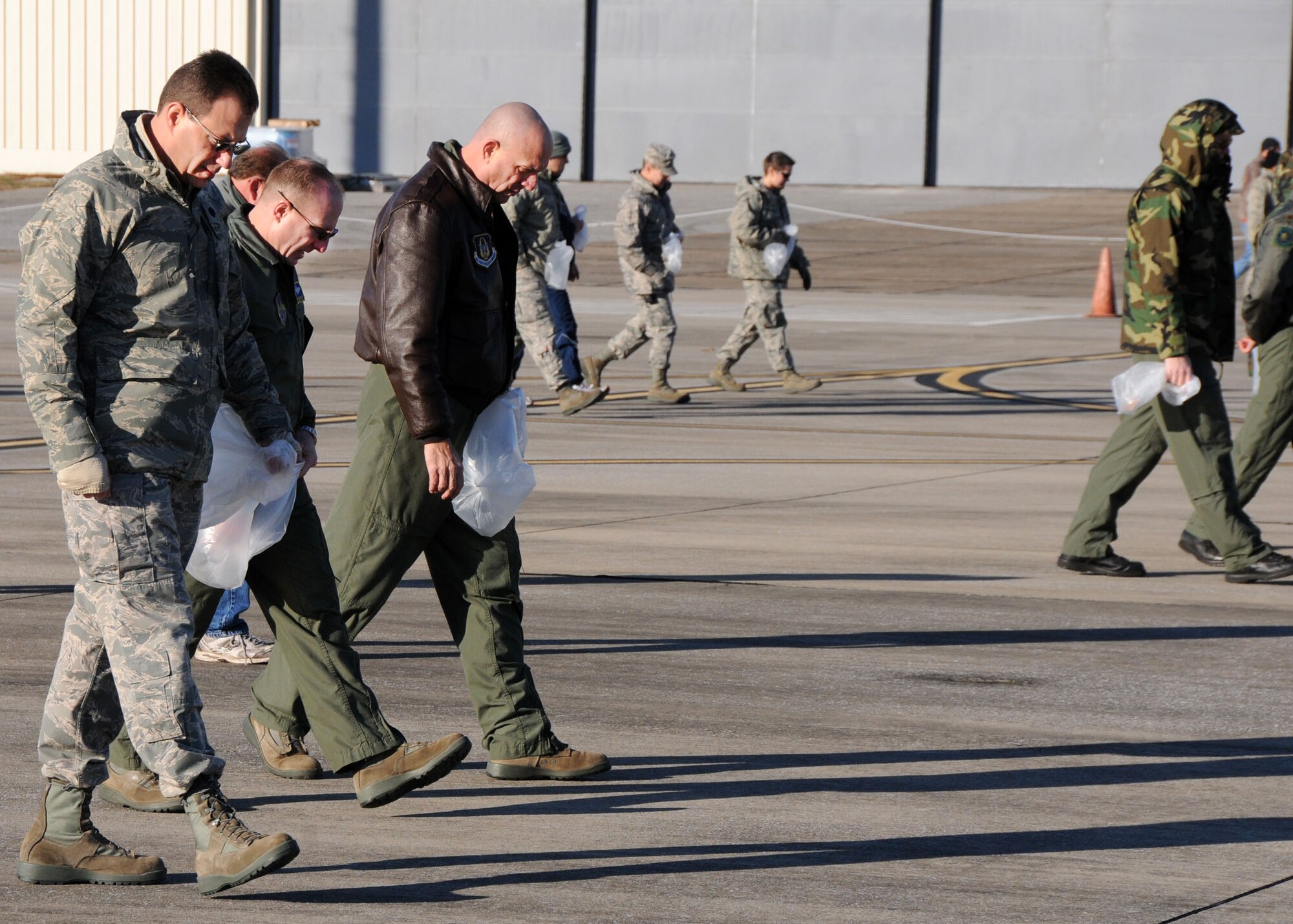 Military and civilian members from across the 919th Special Operations Wing fan out across the Duke Field flightline Jan. 27 to find and remove small foreign objects that could potentially damage operating aircraft there.  The wing commander called on volunteers to help prepare the tarmac for the return of its aircraft temporarily stationed at nearby Eglin Air Force Base, Fla., during an eight-month airfield construction project.  (U.S. Air Force photo/Staff Sgt. Jonathan McCallum)