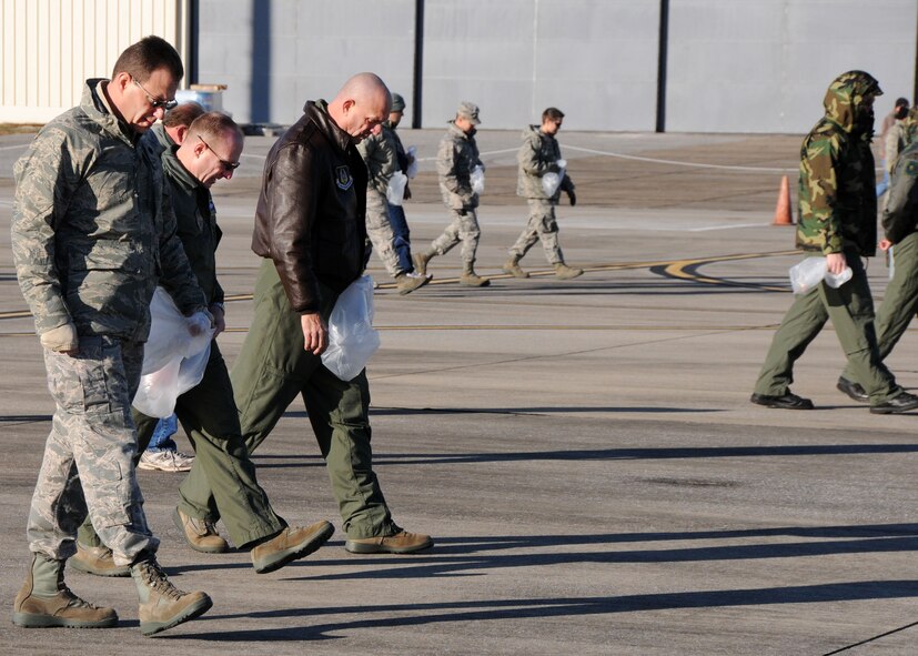 Military and civilian members from across the 919th Special Operations Wing fan out across the Duke Field flightline Jan. 27 to find and remove small foreign objects that could potentially damage operating aircraft there.  The wing commander called on volunteers to help prepare the tarmac for the return of its aircraft temporarily stationed at nearby Eglin Air Force Base, Fla., during an eight-month airfield construction project.  (U.S. Air Force photo/Staff Sgt. Jonathan McCallum)
