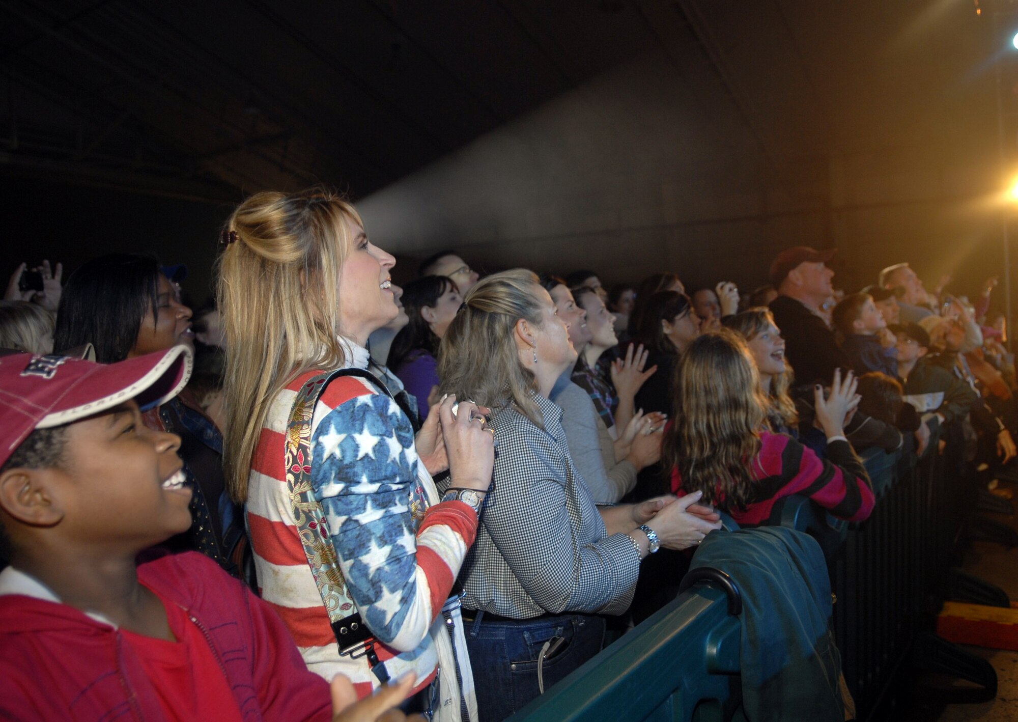 Cindy Wilsbach, wife of 18th Wing Commander Brig. Gen. Ken Wilsbach, and Charlotte Rupp, wife of 18th Wing vice commander Col. Ricky Rupp, stand front row at the Montgomery Gentry USO concert Jan. 28. Mrs. Wilsbach and Mrs. Rupp welcomed the country duo to Kadena earlier in the day during a briefing conducted by Colonel Rupp. (U.S. Air Force photo/ Airman 1st Class Tara A. Williamson)
