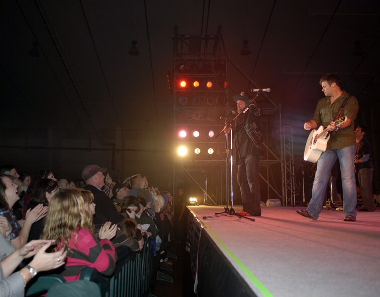 Country duo Montgomery Gentry play a concert for service members and their families on Kadena Air Base, Japan, Jan. 28, during the last of a four-stop USO tour. The duo also had two ‘meet and greets’ earlier in the day to give service members on Okinawa the chance to get a picture or autograph. (U.S. Air Force photo/ Airman 1st Class Tara A. Williamson)