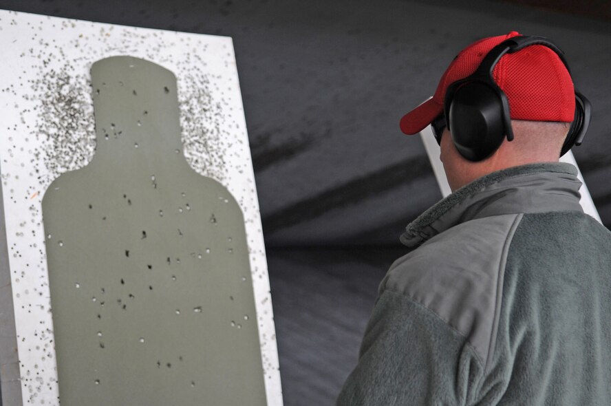 Staff Sgt. Kevin Hillman, 2nd Security Forces Squadron combat arms instructor, studies his target after a practice round with the M870 Shotgun at Barksdale Air Force Base, La., Jan. 31. Each instructor has to qualify for the shotgun annually. The instructor stands 25 meters away to fire and to qualify, there needs to be 25 hits on the target.  (U.S. Air Force photo/Senior Airman Alexandra M. Boutte) (RELEASED)