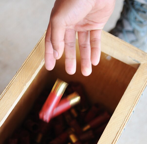 Staff Sgt. Michael Boutte, Jr., 2nd Security Forces Squadron combat arms instructor, disposes M870 Shotgun rounds at Barksdale Air Force Base, La., Jan. 31. Shotgun rounds has nine pellets in each shell.  (U.S. Air Force photo/Senior Airman Alexandra M. Boutte) (RELEASED)