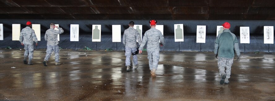 The 2nd Security Forces Squadron combat arms instructors walk to their targets to see their results with the M870 Shotgun at Barksdale Air Force Base, La., Jan. 31. Each instructor performs an annual qualifying course on the shotgun to maintain their proficiency. (U.S. Air Force photo/Senior Airman Alexandra M. Boutte) (RELEASED)