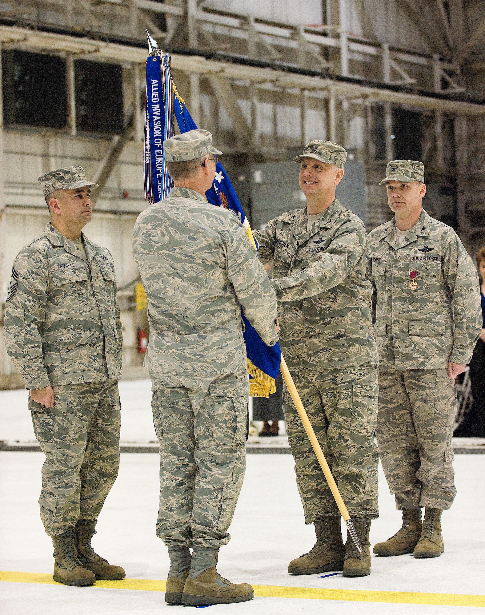 Col. Mark Camerer takes the wing guidon from Lt. Gen. Robert Allardice, 18th Air Force commander, during the 436th Airlift Wing change of command ceremony Jan. 27, 2011, Dover Air Force Base, Del. The passing of the guidon is a symbolic gesture of the change in command of the 436 AW to Col. Camerer from Col. Manson Morris.  (U.S. Air Force photo/Jason Minto)
